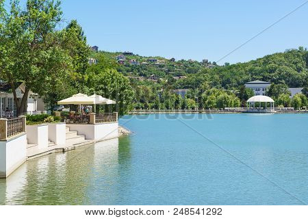 Pier And Summer Cafe On The Shore Of Lake Abrau In The Resort Village. Sunny Summer Day