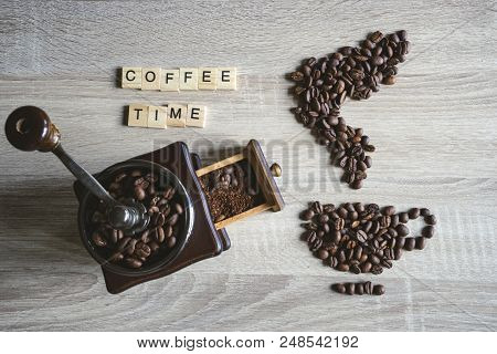 Coffee Time Quote Word With Roasted Coffee Beans Placed In The Shape Of A Cup And Saucer On Wooden B