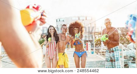 Happy Friends Doing Battle With Water Guns Next Port Harbor - Young Millennials People Laughing And 