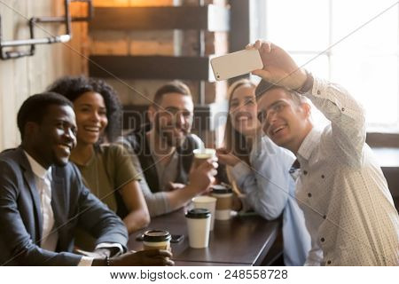 Millennial Multiracial Friends Smiling Posing For Camera, Taking Self-portrait On Smartphone While E