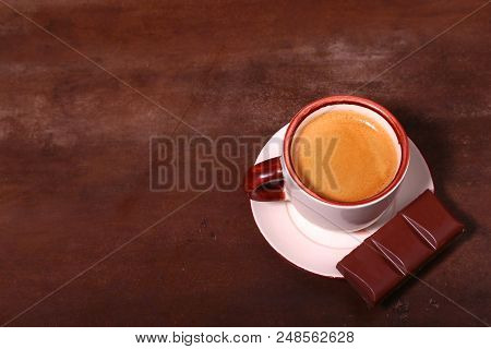 Coffee Cup And Chocolate On Wooden Table Texture. Coffeebreak.