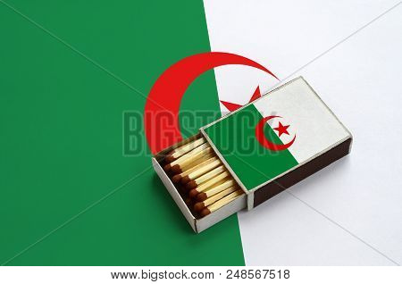Algeria Flag  Is Shown In An Open Matchbox, Which Is Filled With Matches And Lies On A Large Flag.