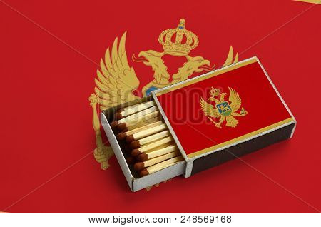 Montenegro Flag  Is Shown In An Open Matchbox, Which Is Filled With Matches And Lies On A Large Flag