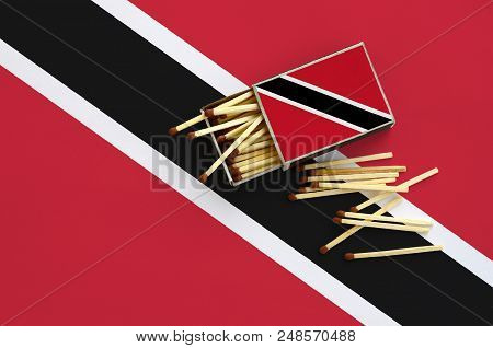 Trinidad And Tobago Flag  Is Shown On An Open Matchbox, From Which Several Matches Fall And Lies On 