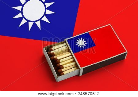 Taiwan Flag  Is Shown In An Open Matchbox, Which Is Filled With Matches And Lies On A Large Flag.