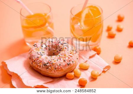 Sprinkled Pink Donut. Frosted Sprinkled Donut On Pink Background.