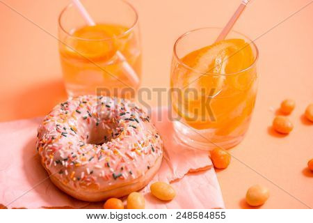 Sprinkled Pink Donut. Frosted Sprinkled Donut On Pink Background.