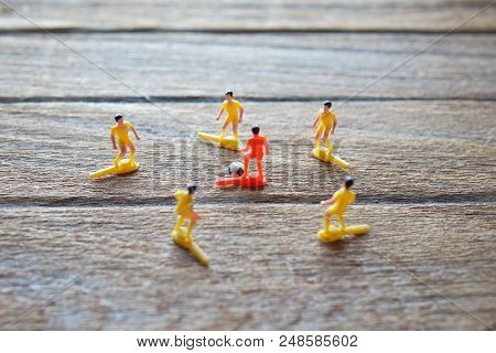 Old Soccer Players Toys On Wood Table. Team/teamwork