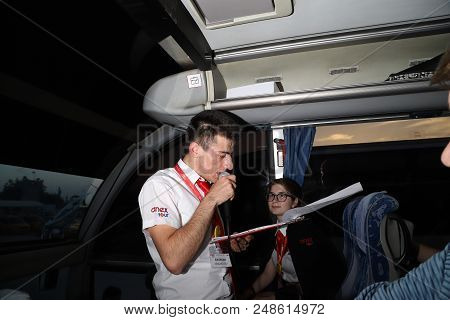 Marmaris, Turkey - May 19, 2018: Male Tour Guide With A Microphone In The Bus In Evening Time