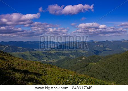 Photo Of Mountain Landscape In The Summer Under Beautiful Cloudy Sky. Ukraine, Carpathians, Dzembron