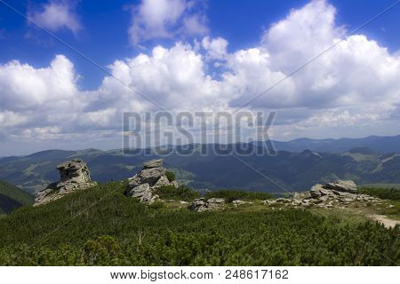 Photo Of Mountain Landscape In The Summer Under Beautiful Cloudy Sky. Ukraine, Carpathians, Dzembron