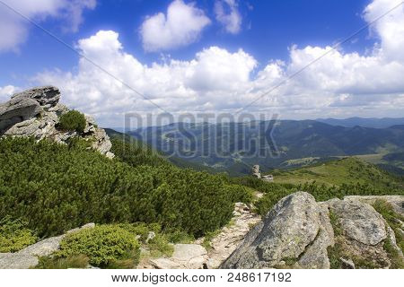 Photo Of Mountain Landscape In The Summer Under Beautiful Cloudy Sky. Ukraine, Carpathians, Dzembron
