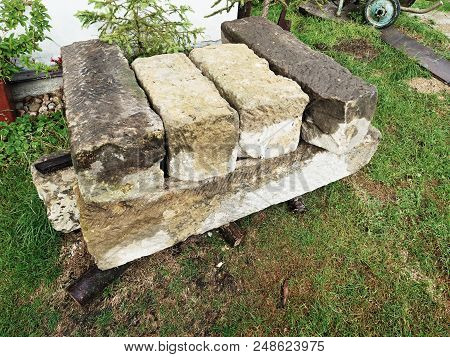 Autentic And Decorative Building Stones In Pile. Old Heavy Sandstone Blocks Rest After Rebuilding.