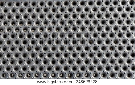 A Close View Of Perforated And Patterend Shiny Metal Sheet. Suitable For Use As A Background.
