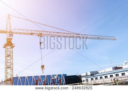 Construction Crane Tower On Blue Sky Background. Crane And Building Working Progress. Worker. Empty 
