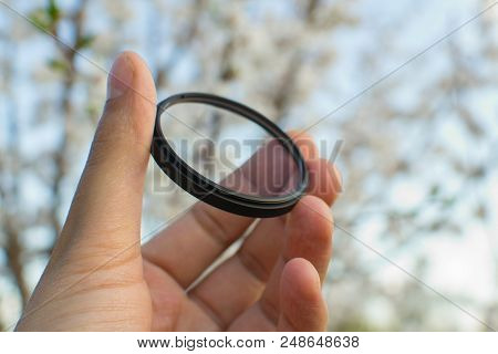 Protective Filter For The Lens Photographer Is Holding A Uv Filter