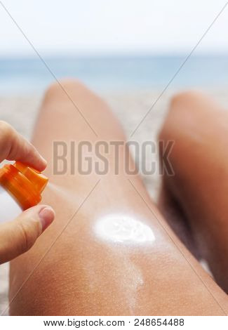 Spraying Creme On Body, Summer Beach And Ocean,soft Focus