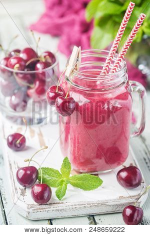Healthy Cherry Smoothie With Frozen Strawberry, Coconat Water And Honey In Glass On White Wooden Tab