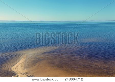 Sandy Shoreline And Sandbanks In The Water.
