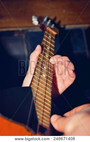 The Boy Plays The Guitar And Takes Chords, Dombra On The Background Of The Piano.