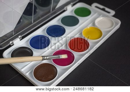 School Supplies On A Red Background, Paints And Brushes