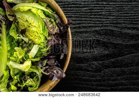Fresh Green Lettuce Red Little Gem Variety Chopped In A Wooden Bowl Flatlay On Black Wood