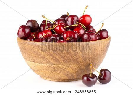 Sweet Bright Red Cherry In A Wooden Bowl And Two Is Near It Isolated On White