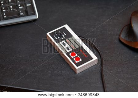 BUDAPEST, HUNGARY - FEBRUARY 17, 2018: Classic Nintendo NES console controller from the 80s on a desk