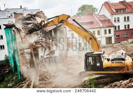 excavator crasher machine at demolition on construction site
