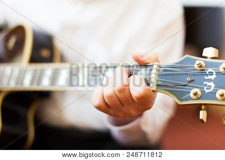 Guitarist playing an archtop guitar