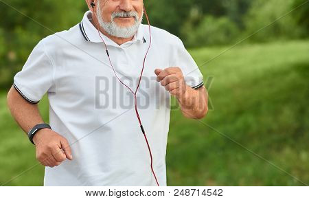 Cropped Frontview Of Running Old Man Having White Beard. Wearing Classic White Polo Shirt With Dark 