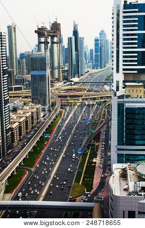 Dubai, United Arab Emirates - April 3, 2018: Busy Sheik Zayed Road Surrounded By Modern Skyscrapers 