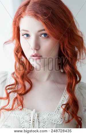 Tender Retro Portrait Of A Young Beautiful Dreamy Redhead Woman.