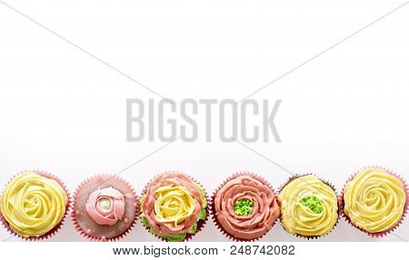 Capcake With Yellow And Pink Cream On A White Background. Isolate.