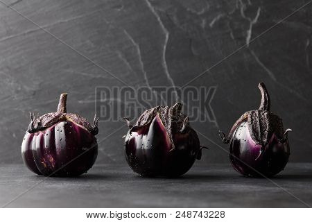 Fresh Italian Type Eggplants Or Aubergines With Water Drops Closeup On Black Background