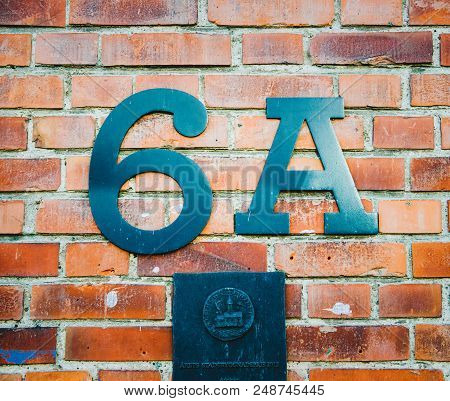 Copenhagen, Denmark - Dec 29, 2014: 6a Sign Address On A Brick Wall In With Steel Totem Of The City
