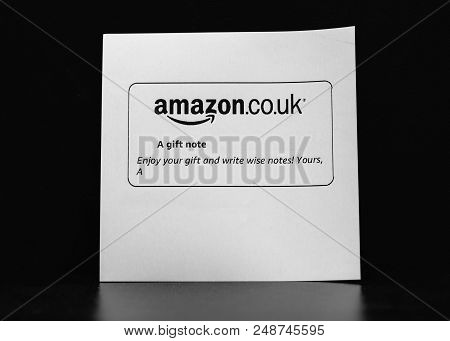 London United Kigdom - Jan 26 2018: Amazon.co.uk Gift Paper Slip With Mesage To Friend Against Black