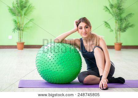 Woman doing exercises with swiss ball