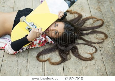 Cute Pretty And Successful. Closeup Portrait Head Shot Beautiful Brunette Young Woman  Holding Skate