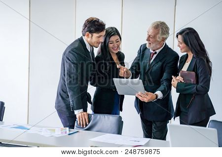 group of successful businessman. Discussion of the business profits of the company in meeting roon o