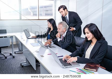 group of successful businessman. Discussion of the business profits of the company in meeting roon o