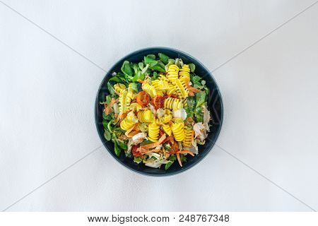 Salad made from radiatori cooked pasta, goat cheese and oil vinaigrette