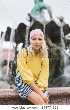 Attractive Woman Looking At Camera In Front Of Neptunbrunne In Berlin, Germany