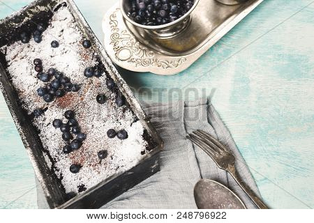 Berry Crumble In The Baking-tin On The Blue Wooden Table. Top View With Selective Focus