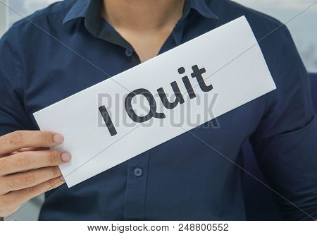 Close Up Businessman Hold Paper Sheet Of I Quit As Resignation Letter From The Office