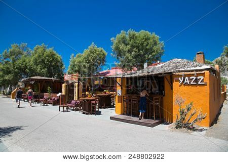 PERMISSA, GREECE- JUN 11, 2016: Caffe bar in Permissa at main road near black sand beach in Santorini on Jun 11, 2016. Greece. 