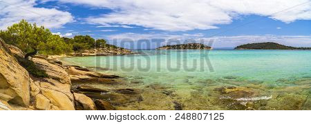 Beautiful Panorama With The Mediterranean Sea In Greece. Crystal And Colorful Water, Rocks, Vegetati