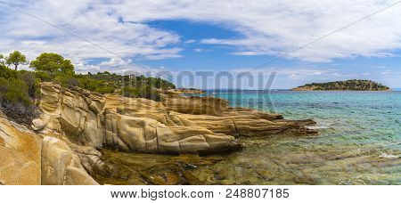 Beautiful Panorama With The Mediterranean Sea In Greece. Crystal And Colorful Water, Rocks, Vegetati