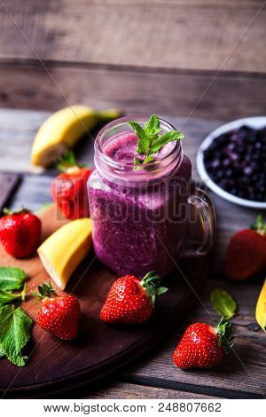 Blueberry Smoothies On A Wooden Background With Fruits. Vitamins A