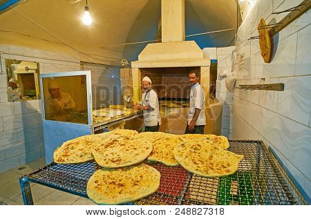 Kerman, Iran - October 15, 2017: The Bakers Make Traditional Tasty Flatbread In Open Bakery, Located